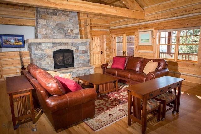8337 Lamar Trl, Lolo, MT 59847 - living room featuring wooden walls, wood finished floors, a fireplace, and wooden ceiling