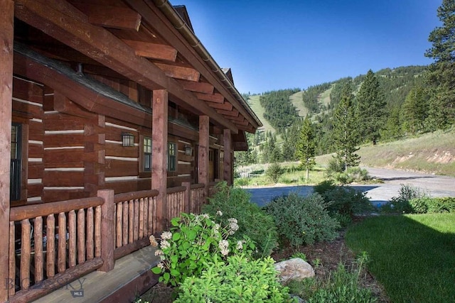 8337 Lamar Trl, Lolo, MT 59847 - view of side of home with log siding and a forest view