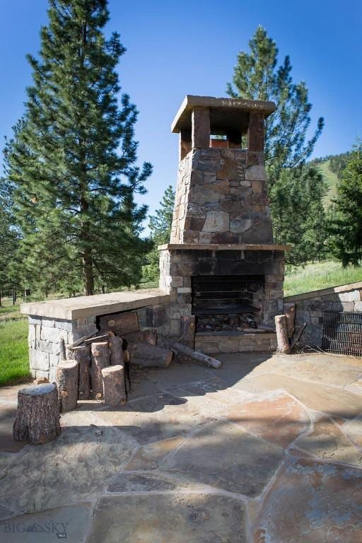 8337 Lamar Trl, Lolo, MT 59847 - view of patio with an outdoor stone fireplace