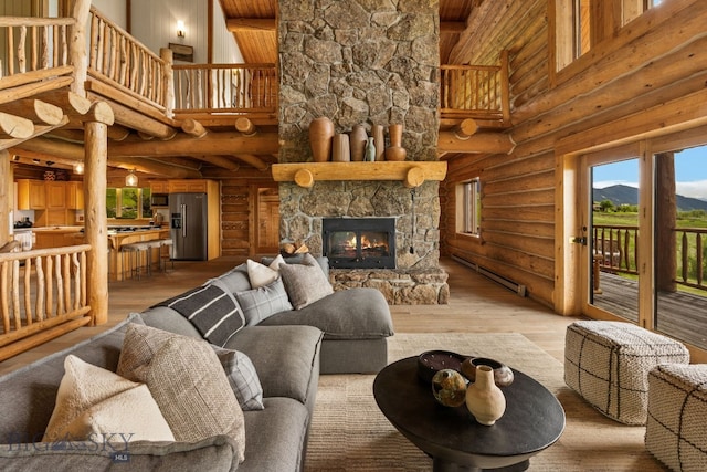 FourBarRanches Corbly Gulch, Belgrade, MT 59714 - living area with high vaulted ceiling, light wood-style flooring, a wood ceiling with exposed beams, rustic walls, and a fireplace