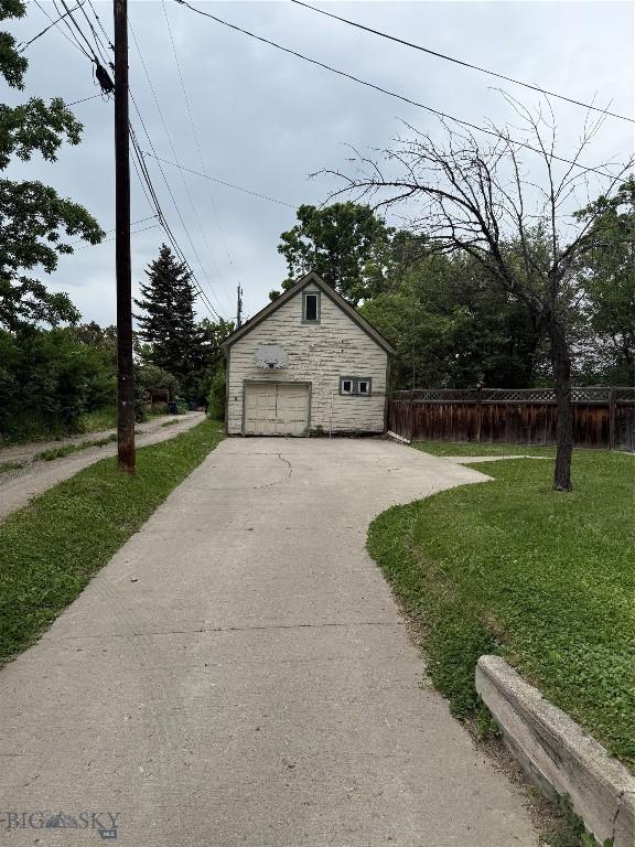 221 S 7th Ave, Bozeman, MT 59715 - view of home's exterior featuring a garage, an outdoor structure, and asphalt driveway