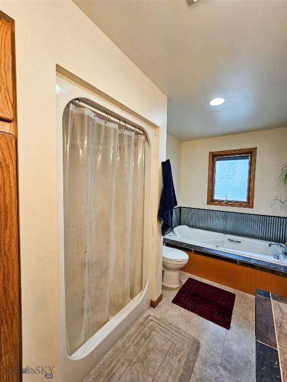 400 E 9th Ave, Big Timber, MT 59011 - bathroom featuring a garden tub, a shower with shower curtain, and recessed lighting