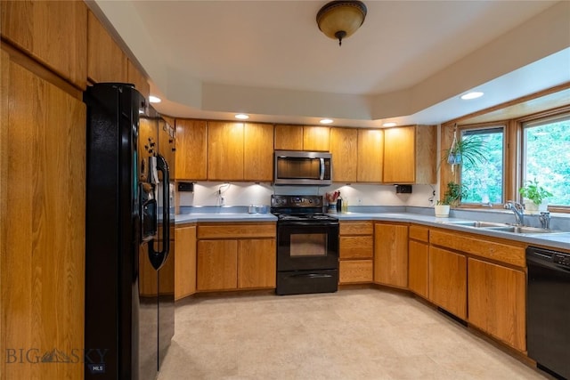 400 E 9th Ave, Big Timber, MT 59011 - kitchen with black appliances, brown cabinetry, light countertops, and recessed lighting