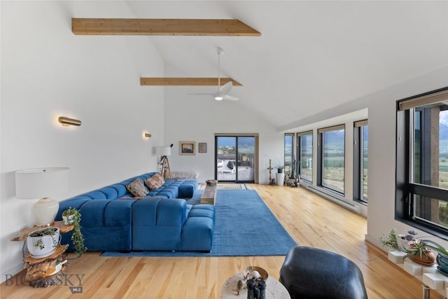 145 Spring Creek Hills Rd, Livingston, MT 59047 - living area featuring beam ceiling, high vaulted ceiling, wood finished floors, and a ceiling fan