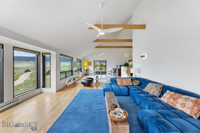 145 Spring Creek Hills Rd, Livingston, MT 59047 - living room with a ceiling fan, wood finished floors, beam ceiling, baseboard heating, and high vaulted ceiling