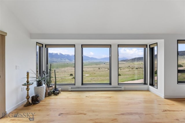 145 Spring Creek Hills Rd, Livingston, MT 59047 - unfurnished room featuring a baseboard radiator, wood finished floors, and a mountain view