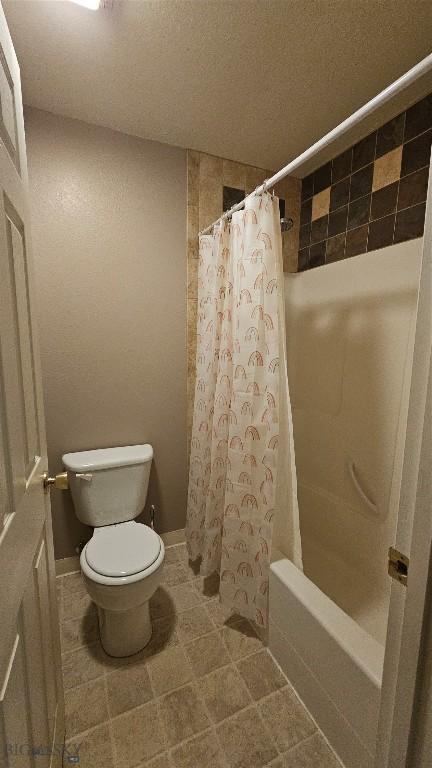 835 Forestglen Unit H, Bozeman, MT 59718 - full bath with shower / bath combo with shower curtain, a textured ceiling, and tile patterned flooring