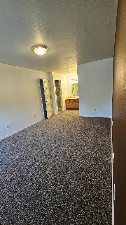 835 Forestglen Unit H, Bozeman, MT 59718 - spare room featuring a textured ceiling and carpet floors