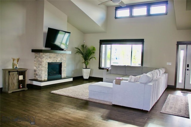 176 Travelers, Manhattan, MT 59741 - living room with a high ceiling, a ceiling fan, a stone fireplace, and wood finished floors