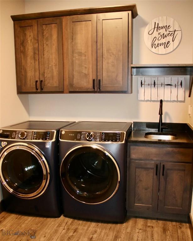 176 Travelers, Manhattan, MT 59741 - laundry area with separate washer and dryer, cabinet space, and wood finished floors