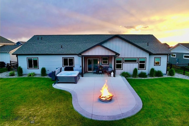 176 Travelers, Manhattan, MT 59741 - back of house featuring a patio area, board and batten siding, roof with shingles, and an outdoor living space with a fire pit