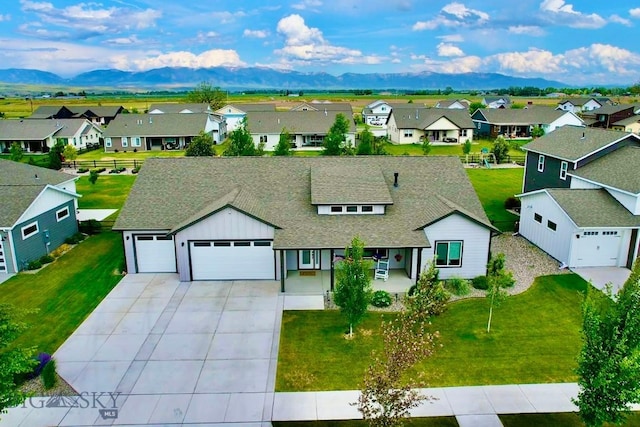 176 Travelers, Manhattan, MT 59741 - view of front of house with a residential view, an attached garage, a shingled roof, and concrete driveway