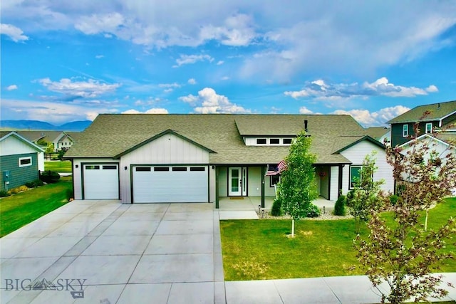 176 Travelers, Manhattan, MT 59741 - view of front facade with an attached garage, driveway, roof with shingles, and a front yard