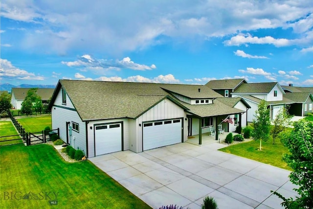 176 Travelers, Manhattan, MT 59741 - view of front facade featuring an attached garage, driveway, board and batten siding, roof with shingles, and a porch