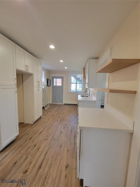 1043 W Galena St, Butte, MT 59701 - kitchen with light wood-style flooring, white cabinets, recessed lighting, open shelves, and light countertops