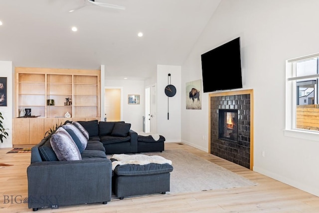 1991 Ryun Sun Way, Bozeman, MT 59718 - living room featuring a tiled fireplace, light wood-style flooring, recessed lighting, a ceiling fan, and high vaulted ceiling