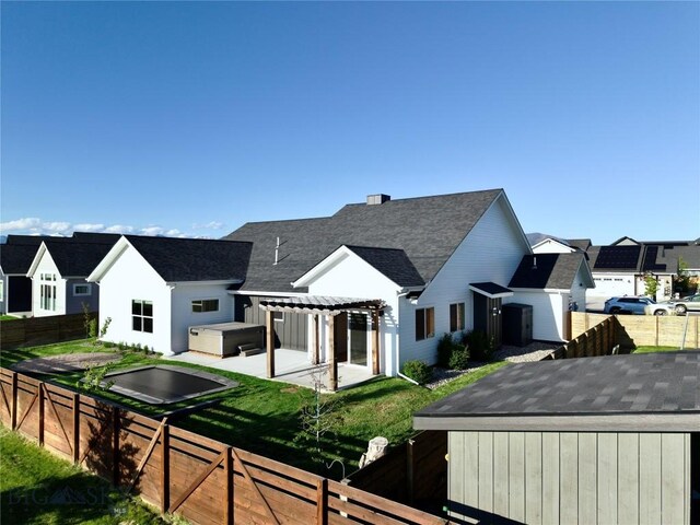 1991 Ryun Sun Way, Bozeman, MT 59718 - rear view of property featuring a hot tub, a pergola, a fenced backyard, roof with shingles, and a residential view