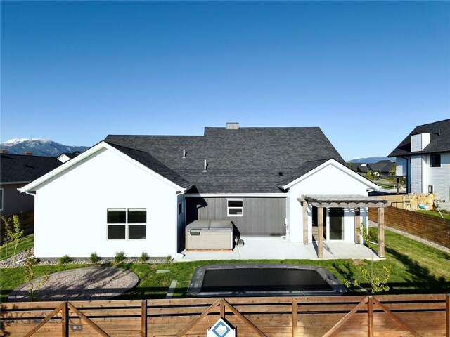 1991 Ryun Sun Way, Bozeman, MT 59718 - rear view of property with a fenced backyard, a pergola, a patio, and roof with shingles