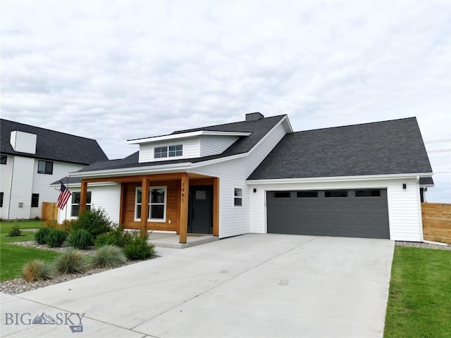 1991 Ryun Sun Way, Bozeman, MT 59718 - view of front of house with a garage, a porch, driveway, and roof with shingles