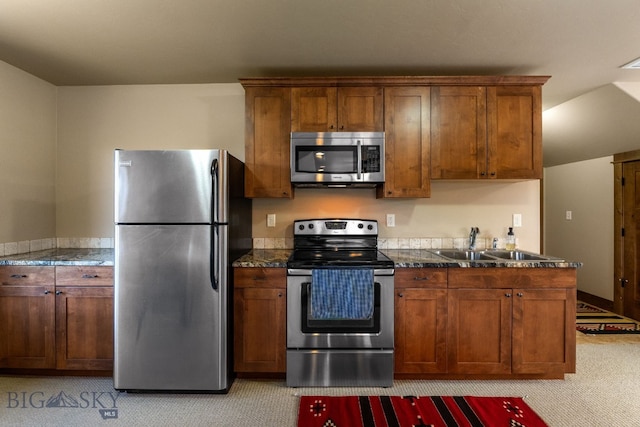 2497 Northview, Bozeman, MT 59715 - kitchen with appliances with stainless steel finishes, light carpet, brown cabinetry, and dark countertops