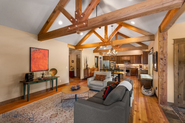 2497 Northview, Bozeman, MT 59715 - living room featuring a chandelier, beamed ceiling, dark wood-type flooring, high vaulted ceiling, and recessed lighting