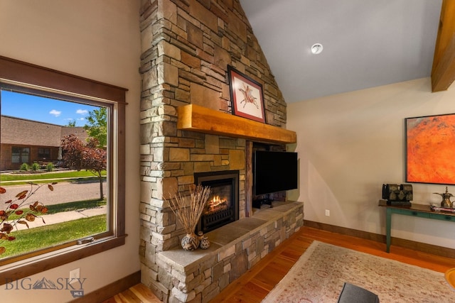 2497 Northview, Bozeman, MT 59715 - living area featuring a stone fireplace, wood finished floors, and high vaulted ceiling