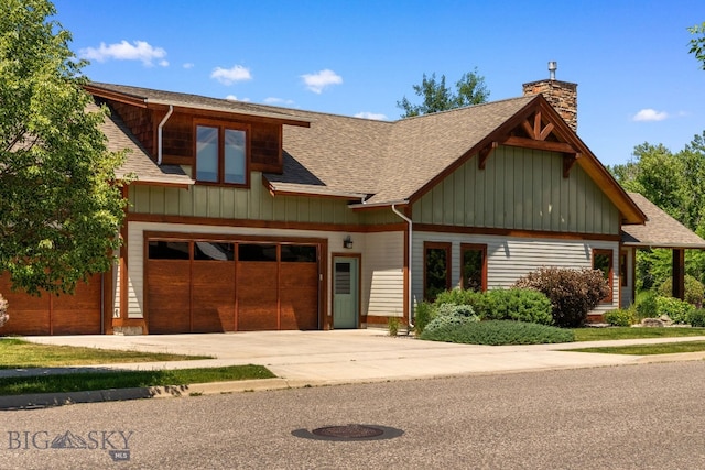 2497 Northview, Bozeman, MT 59715 - view of front of home with roof with shingles, driveway, a chimney, and board and batten siding