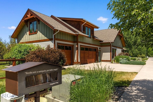 2497 Northview, Bozeman, MT 59715 - view of side of home featuring board and batten siding, driveway, a shingled roof, and an attached garage