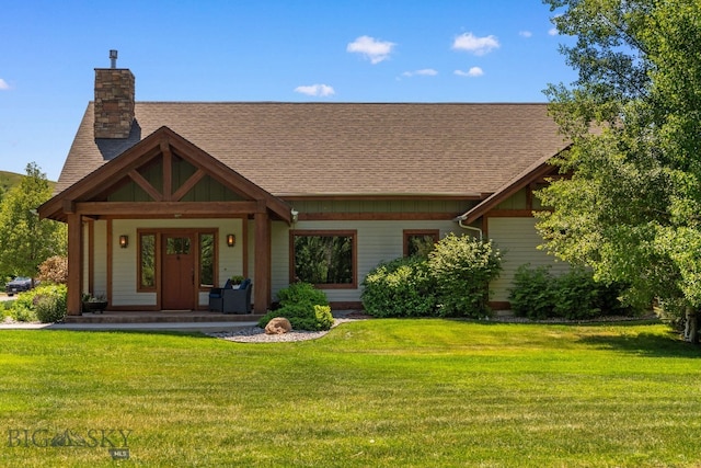 2497 Northview, Bozeman, MT 59715 - view of front of house with roof with shingles, a front lawn, covered porch, and a chimney