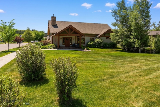 2497 Northview, Bozeman, MT 59715 - view of front of house featuring a front yard, a chimney, a shingled roof, and a porch
