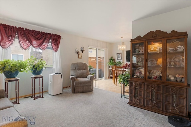 1030 N River Rock St, Belgrade, MT 59714 - living area featuring a chandelier, carpet flooring, and healthy amount of natural light