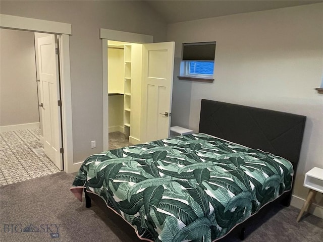 1792 Windrow Dr, Bozeman, MT 59718 - carpeted bedroom featuring vaulted ceiling, a walk in closet, and a closet