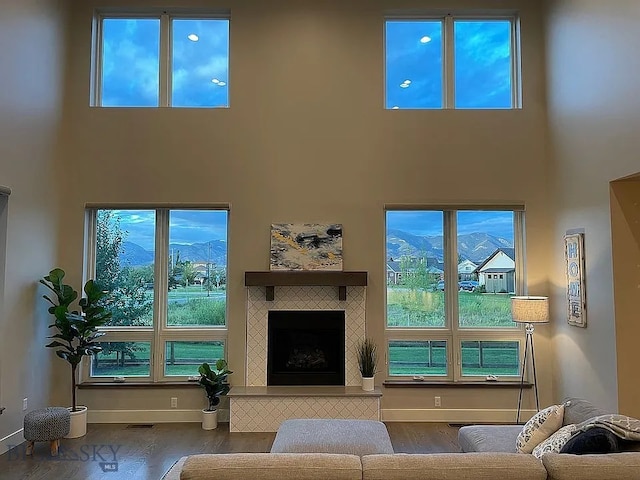 1792 Windrow Dr, Bozeman, MT 59718 - living room featuring a high ceiling, wood finished floors, and a fireplace with raised hearth
