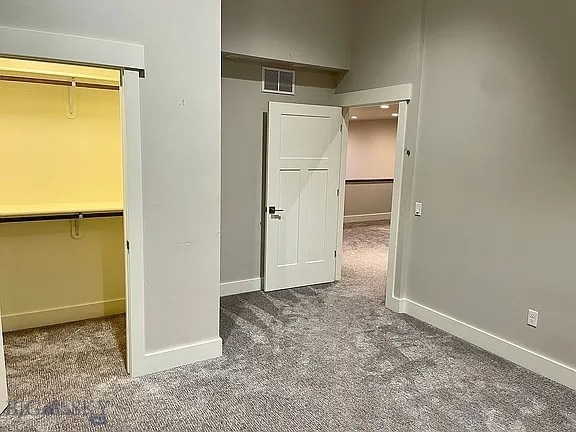 1792 Windrow Dr, Bozeman, MT 59718 - unfurnished bedroom with carpet, a walk in closet, and a closet