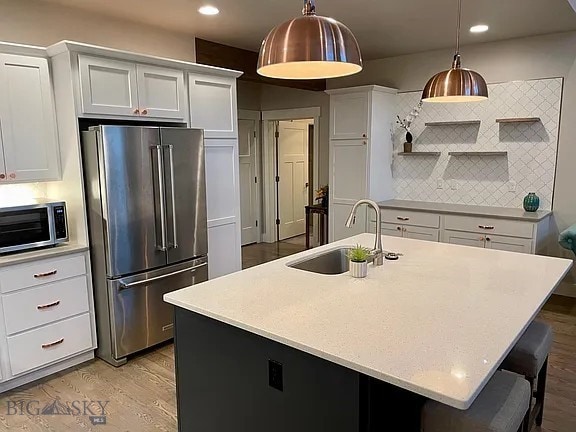1792 Windrow Dr, Bozeman, MT 59718 - kitchen with high quality fridge, open shelves, backsplash, light countertops, and recessed lighting