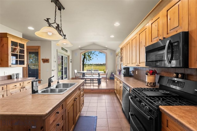164 Wapiti Way, Bozeman, MT 59718 - kitchen with black range with gas cooktop, lofted ceiling, decorative backsplash, stainless steel dishwasher, and light tile patterned floors