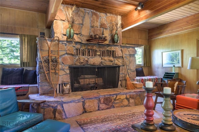 100 Nez Perce Rd, Butte, MT 59701 - living room featuring a wooden ceiling with exposed beams, wood walls, and a stone fireplace