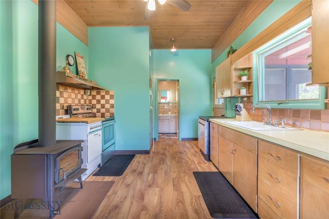 100 Nez Perce Rd, Butte, MT 59701 - kitchen featuring range with electric stovetop, a wood stove, open shelves, decorative backsplash, and light wood-type flooring