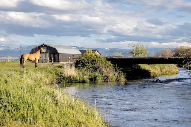 3950 Floweree, Helena, MT 59602 - water view featuring a pole building and a mountainous background