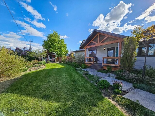 3950 Floweree, Helena, MT 59602 - view of grassy yard featuring covered porch