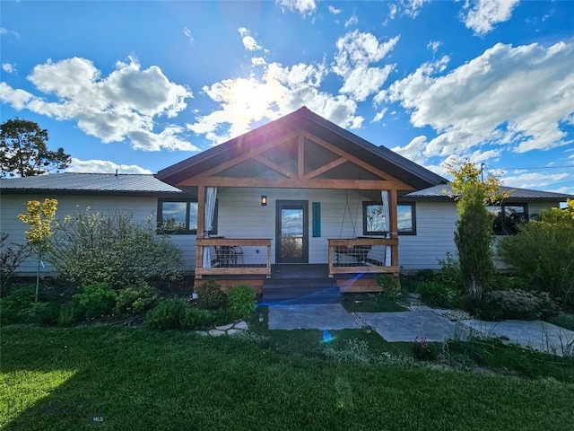 3950 Floweree, Helena, MT 59602 - view of front of property with a front yard, a porch, and a metal roof
