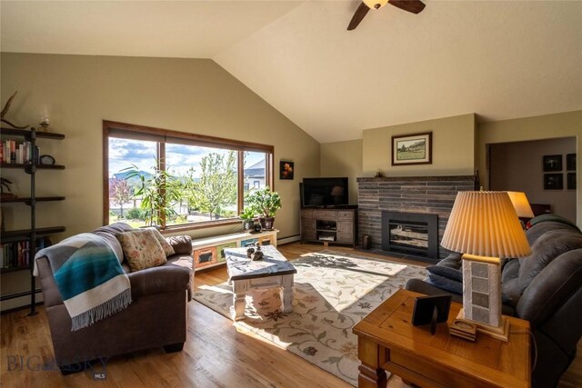 3950 Floweree, Helena, MT 59602 - living room featuring lofted ceiling, wood finished floors, a ceiling fan, baseboard heating, and a fireplace