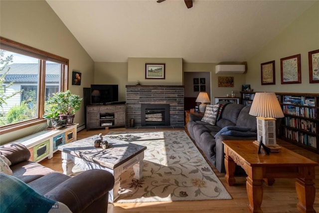 3950 Floweree, Helena, MT 59602 - living room with lofted ceiling, a wall unit AC, wood finished floors, a fireplace with flush hearth, and baseboard heating