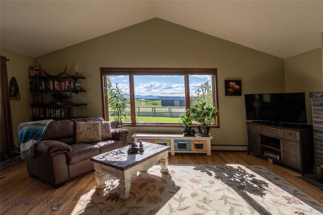 3950 Floweree, Helena, MT 59602 - living area with vaulted ceiling, wood finished floors, and a baseboard heating unit
