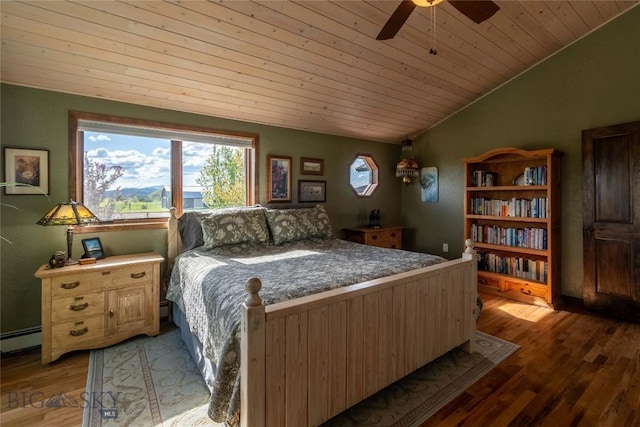 3950 Floweree, Helena, MT 59602 - bedroom with lofted ceiling, multiple windows, wooden ceiling, a baseboard radiator, and wood finished floors