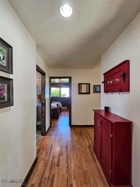 3950 Floweree, Helena, MT 59602 - hallway with a textured ceiling and wood finished floors