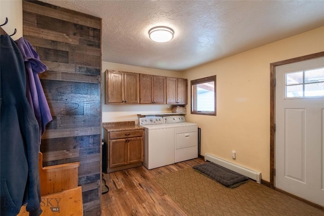 3950 Floweree, Helena, MT 59602 - washroom with a baseboard heating unit, washer and clothes dryer, cabinet space, wood finished floors, and a textured ceiling