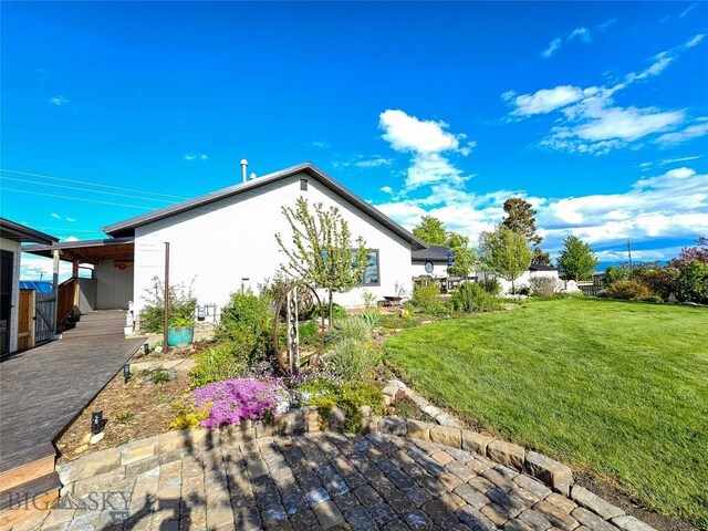 3950 Floweree, Helena, MT 59602 - view of home's exterior featuring a yard and stucco siding