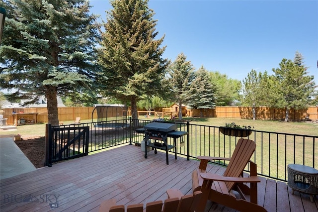 219 W Adams, Three Forks, MT 59752 - wooden deck with a grill and a fenced backyard