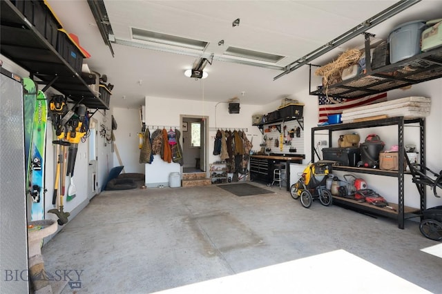 219 W Adams, Three Forks, MT 59752 - garage featuring a workshop area and a garage door opener